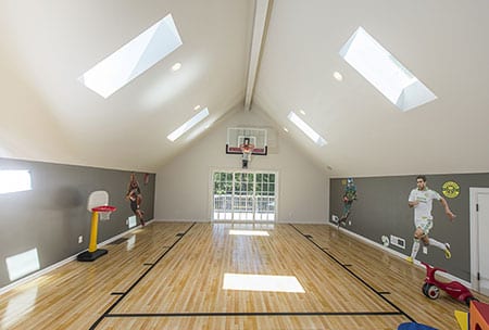 A custom home addition with indoor basketball court | Metke Remodeling and Custom Homes