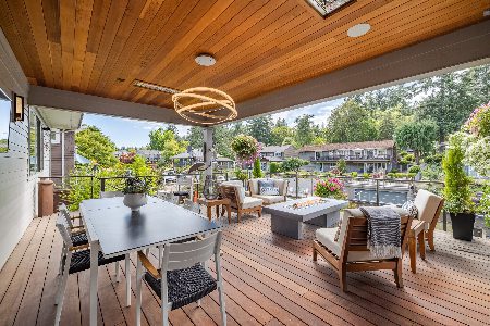 A luxury outdoor area with seating, fire pit, and modern light fixture  to illustrate best renovations to increase home value.
