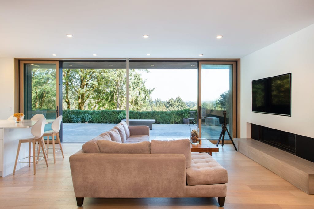 Updated living room with large glass doors opening to an outside fire pit